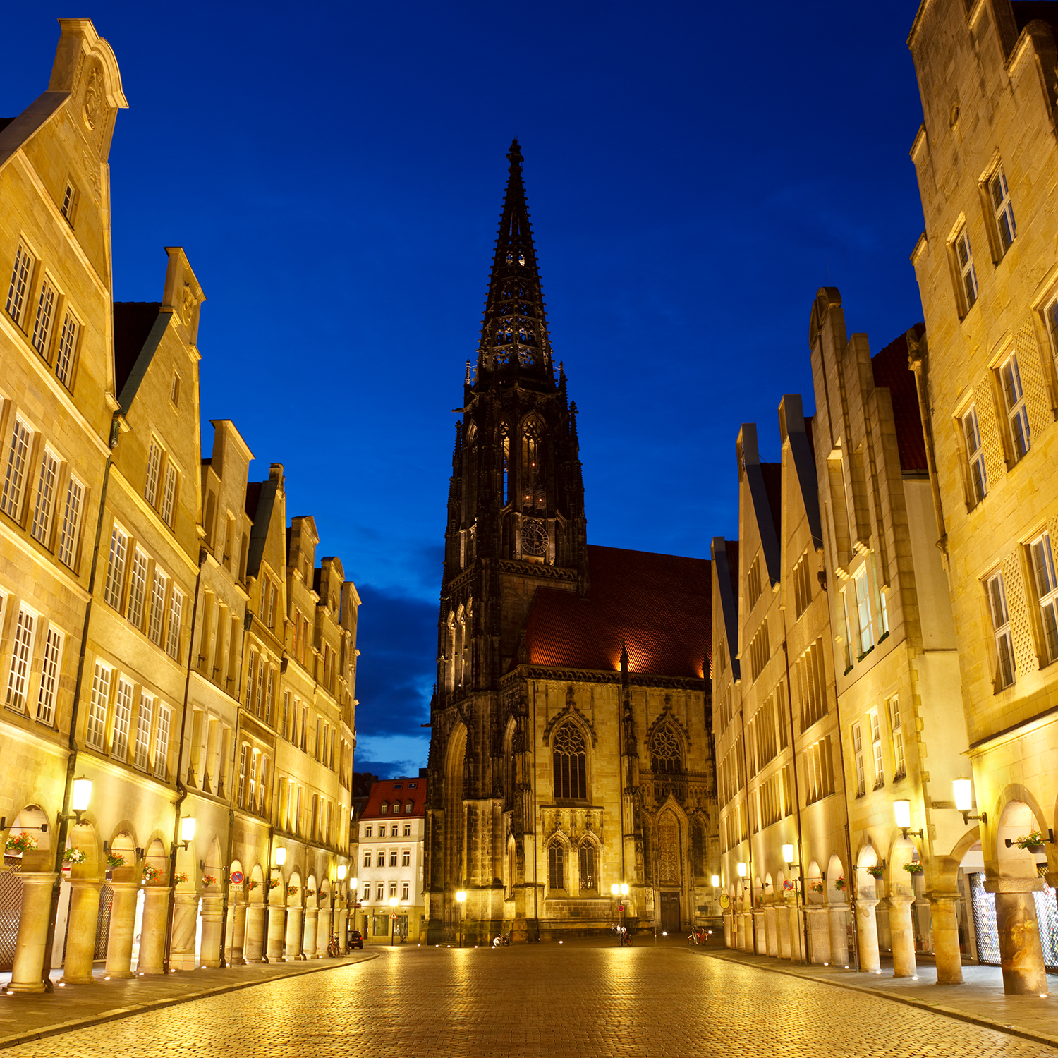 Old City Street And Church At Night, Germany The famous Prinzipalmarkt with the Lamberti Church in Muenster, Germany.
